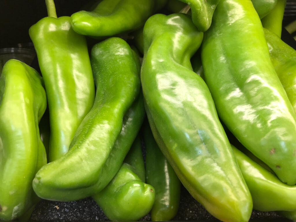 Group of green whole Anaheim peppers