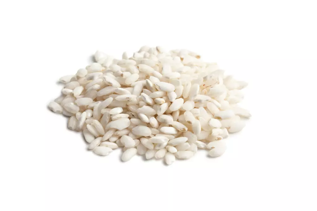 Close up photo of arborio rice grains, another great gluten-free substitute for orzo pasta.