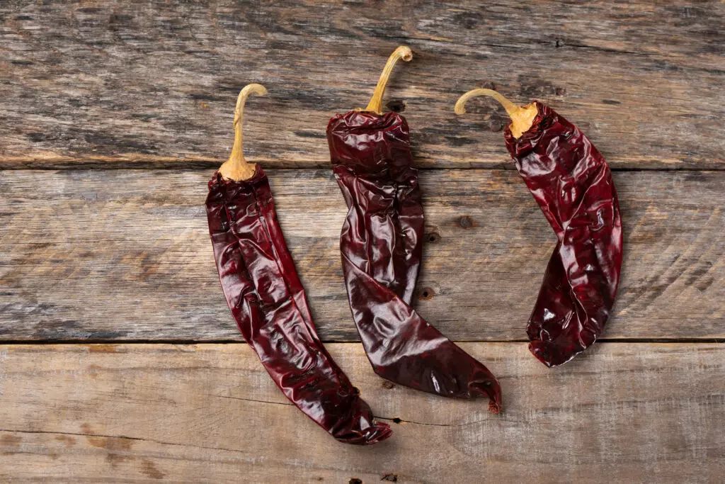 Guajillo chiles, which are a dried pepper and very common in Mexican cooking. When diced and cooked into dishes, these make a great substitute for Anaheim Chiles.