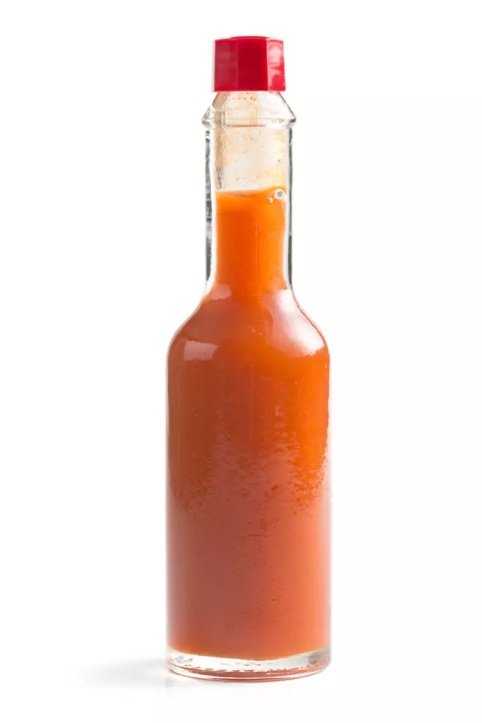 Close up of a bottle of hot sauce.  When used with caution, this can be a great substitute for jalapeño peppers. 