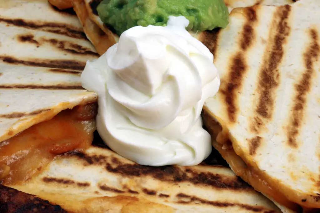 Close up of cream cheese on a quesadilla.  This is a great replacement for cream cheese in savory dishes.