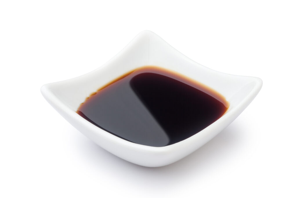 Close up of Soy sauce in a small bowl.  This deep salty flavor make this a great substitute for beef broth when combined with broth or water. 