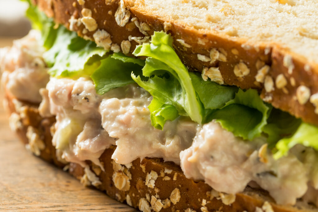 Close up of a tuna salad sandwich.  You should never let your tuna salad sit on the counter for more than two hours. 