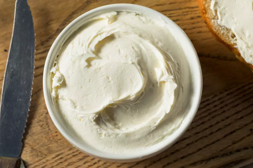 Cream cheese in a cup.  Adding cream cheese is a great way to thicken Alfredo sauce and give it a tangy taste