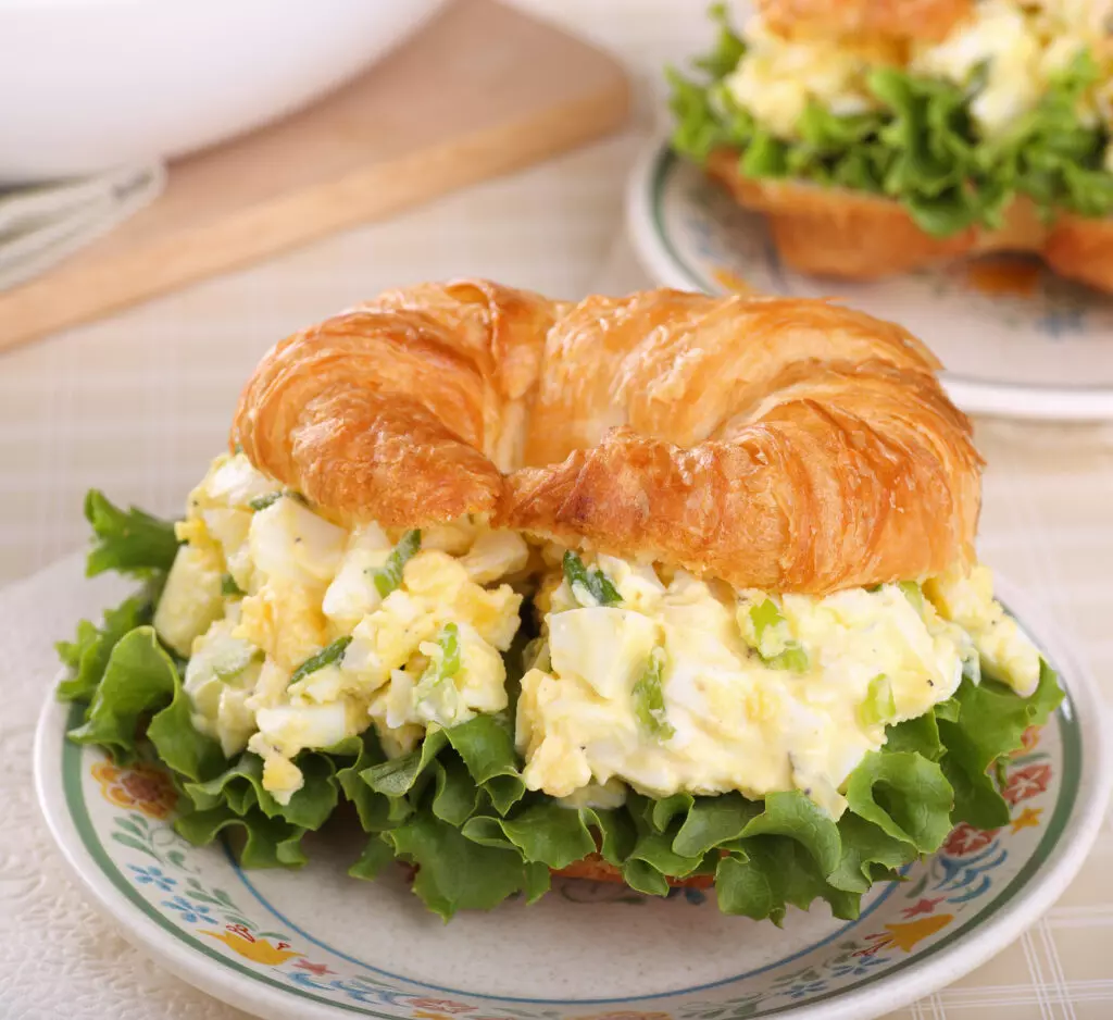 Egg salad sandwich served on a croissant
