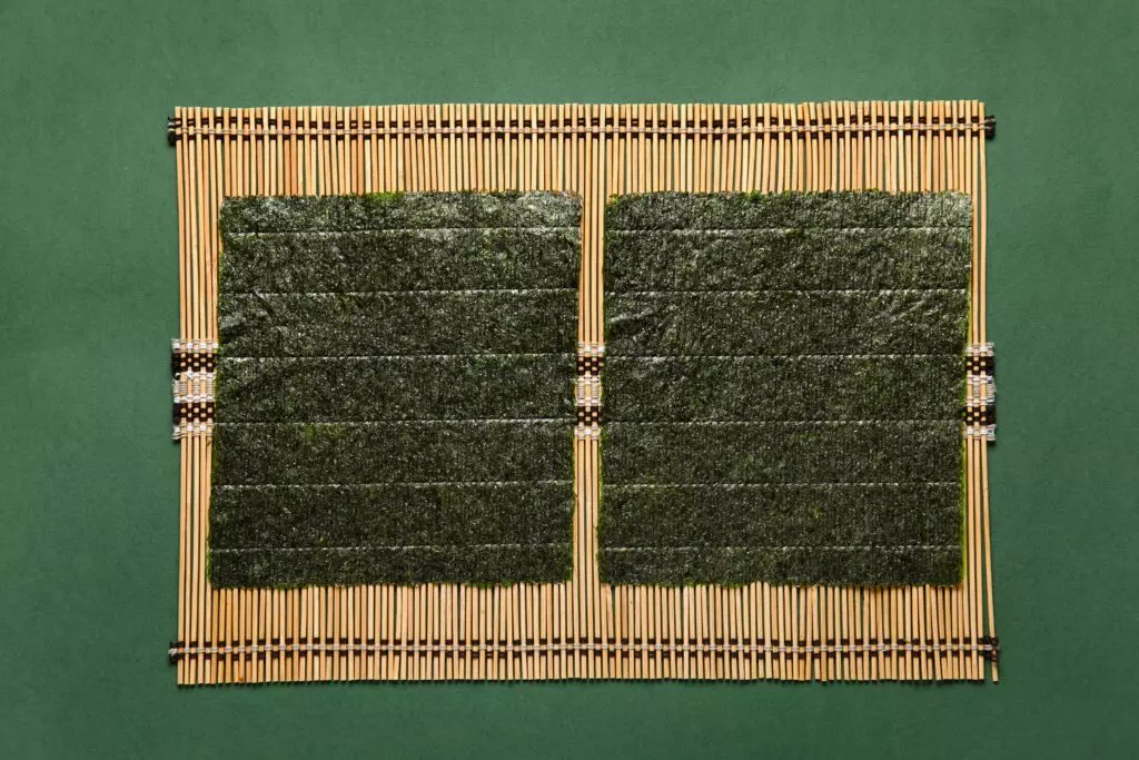 Nori sheets arranged on a bamboo sushi mat
