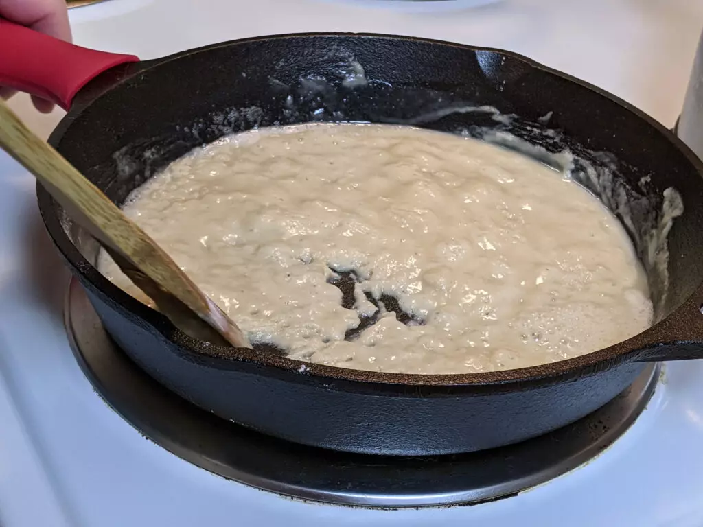 Close up of roux cooking in a cast iron skillet