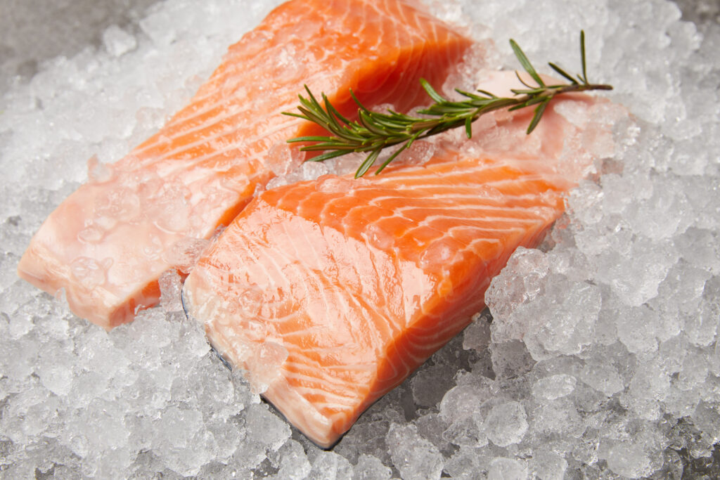 Raw salmon on ice with a sprig of thyme.  I would use your senses when trying to determine if salmon has gone bad.
