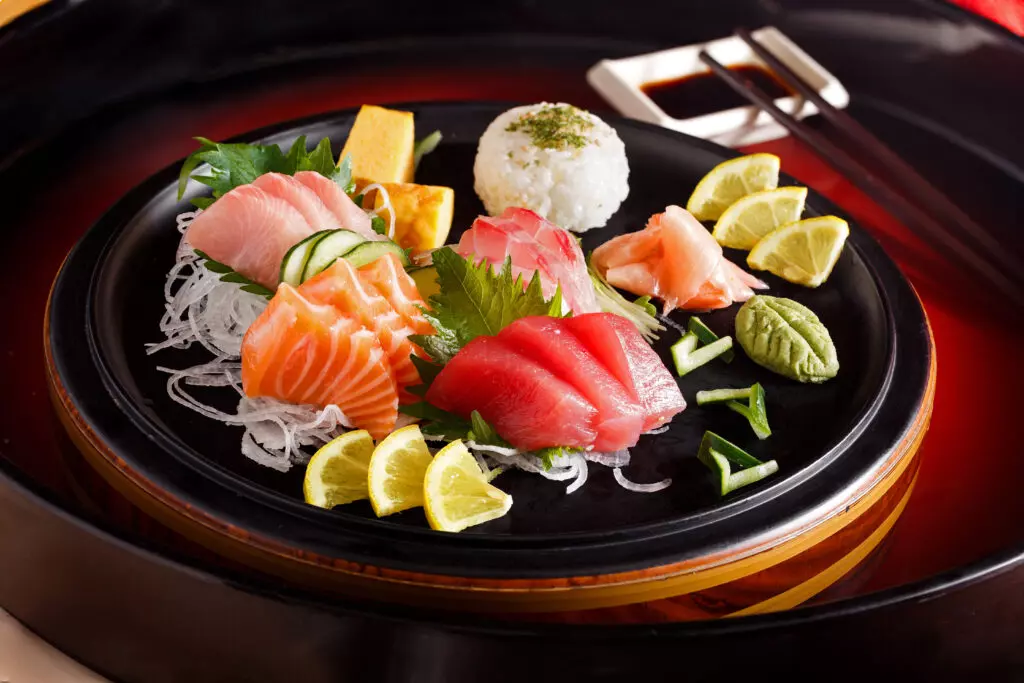 Variety of sashimi on a black plate