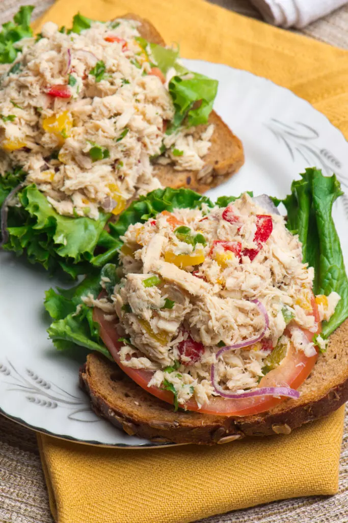 Tuna salad with peppers on bread and lettuce.  While not ideal for the freezer, tuna salad can be safely stored in the freezer for 1-2 months.