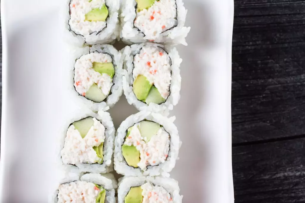 Close up view of California rolls on a platter. 