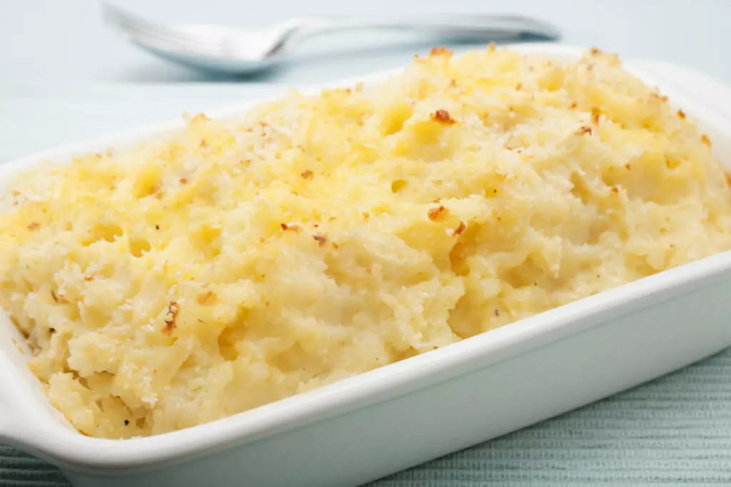 Mashed potatoes out of the oven.  Mashed potatoes should not be left out at room temperature longer than two hours.