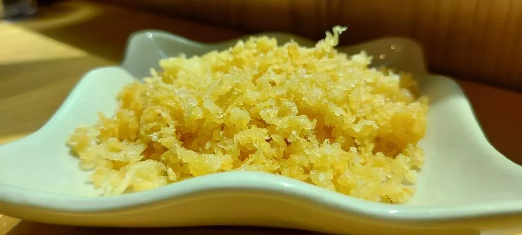 Tempura batter flakes in a bowl.  These are also called tanuki.