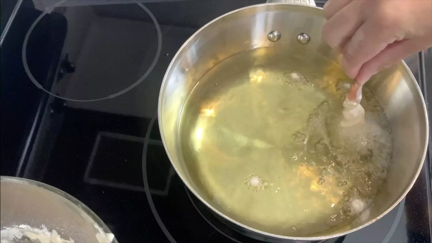 Add battered shrimp to the oil to cook the shrimp tempura.