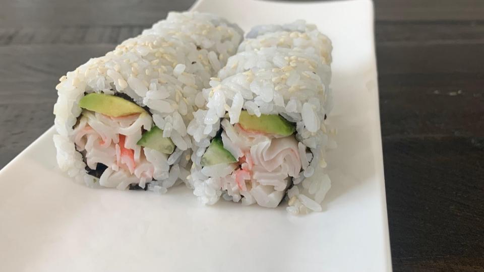 California rolls in two rows on a plate.
