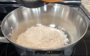 Pouring sushi rice into pot
