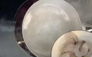 Pouring shrimp into pot