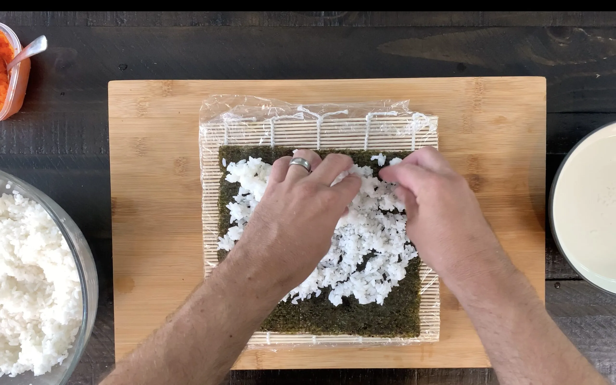 Pressing rice onto nori sheet