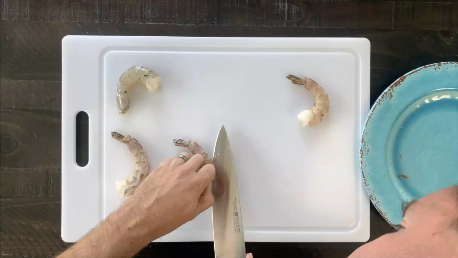 Use a sharp knife to make shallow slice down the back of the shrimp exposing the vein.  Use knife to scrape vein out of shrimp.