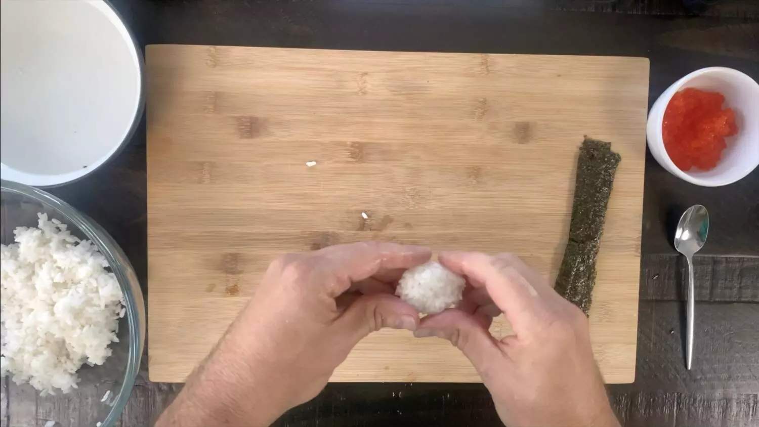 Forming the rice into oval-shaped balls for ikura sushi