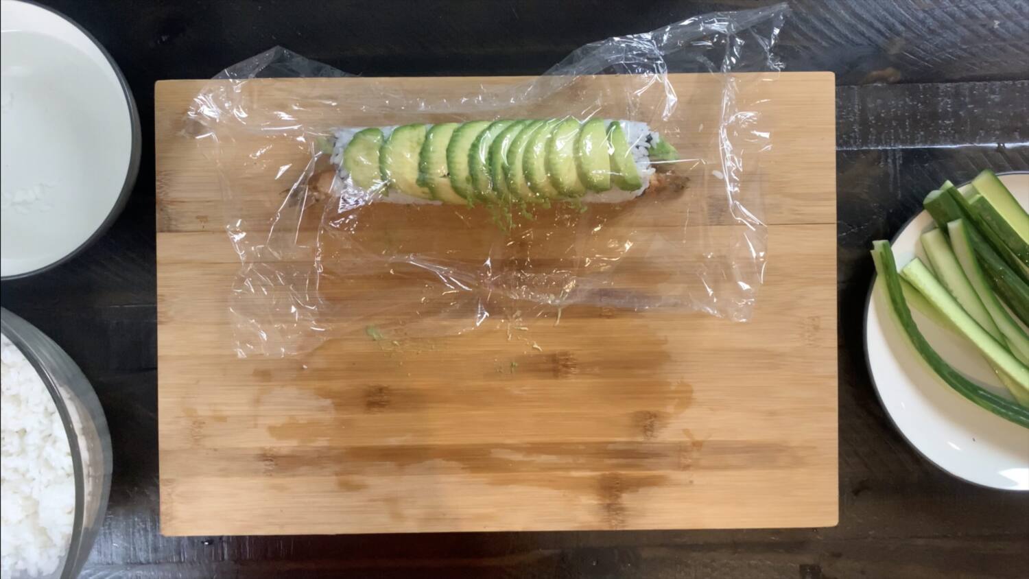 Place plastic wrap over avocado to make cutting the dragon roll easier