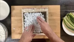Spread rice over nori sheet