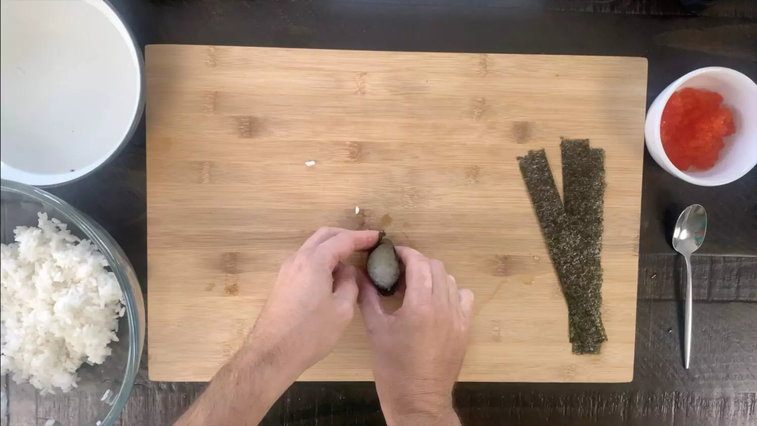 Wrapping the nori sheet around the ball of rice