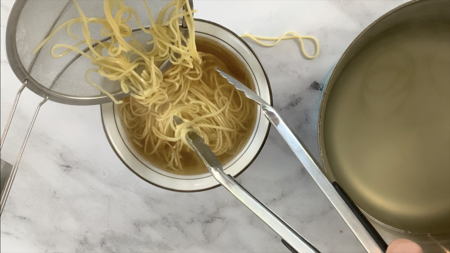 Add noodles to the bowl of broth.