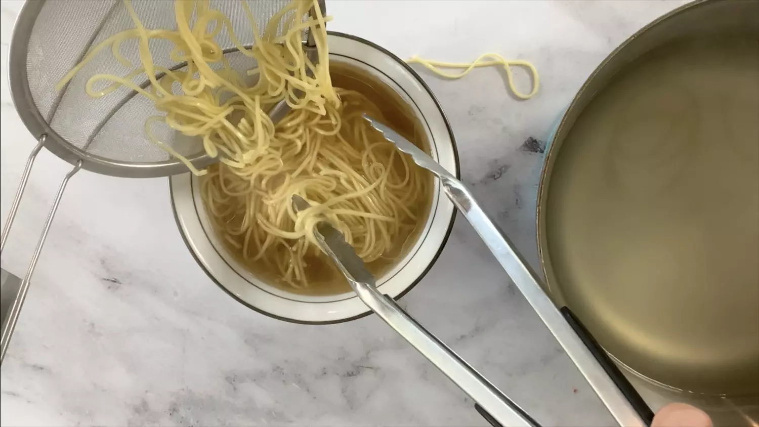 Add noodles to the bowl of broth.