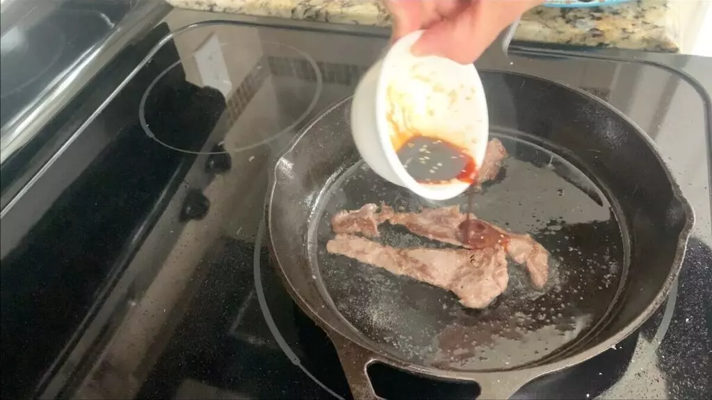 Flip and cook beef in yakiniku sauce