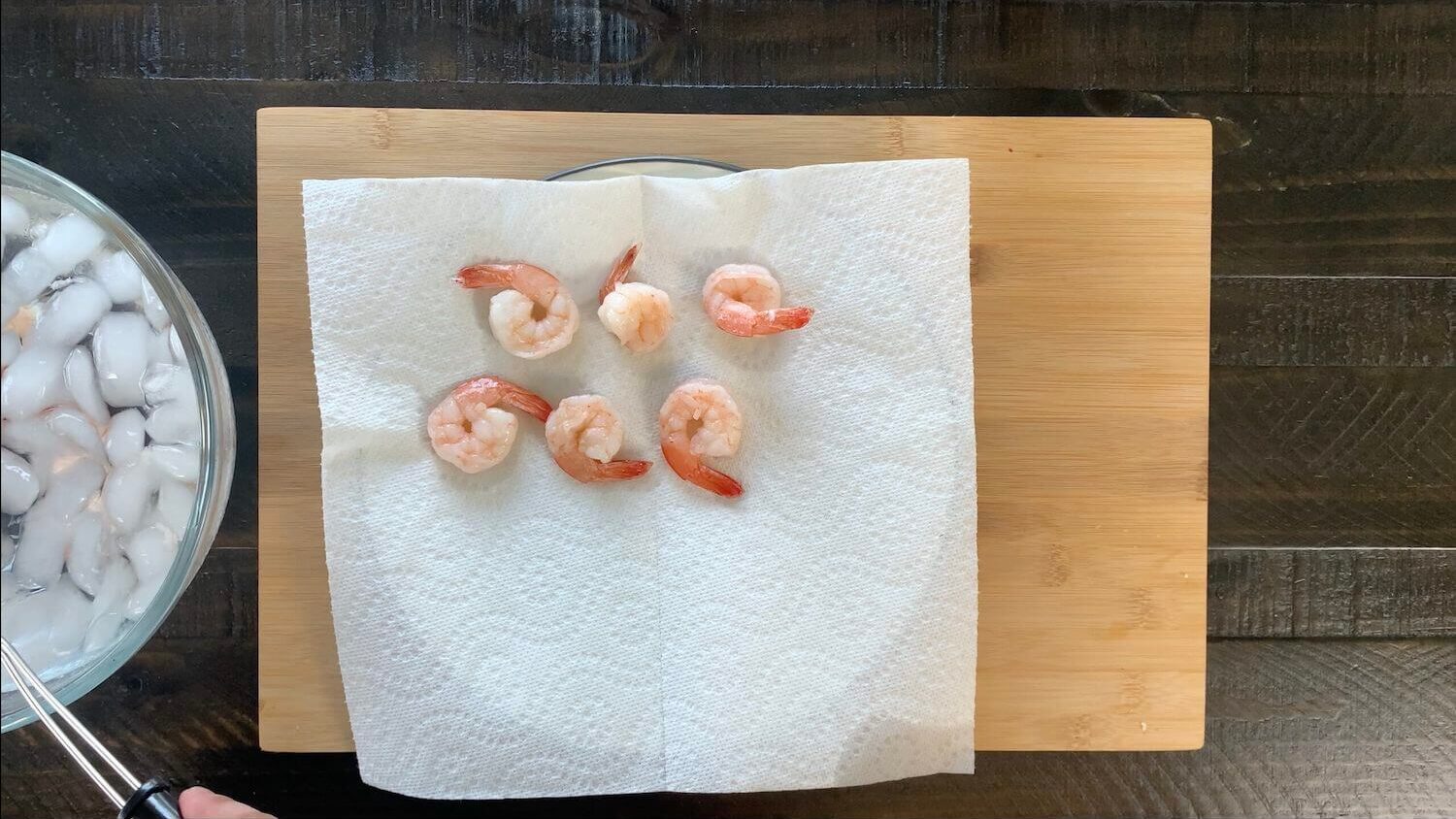 Remove poached shrimp from water and add to paper towel.