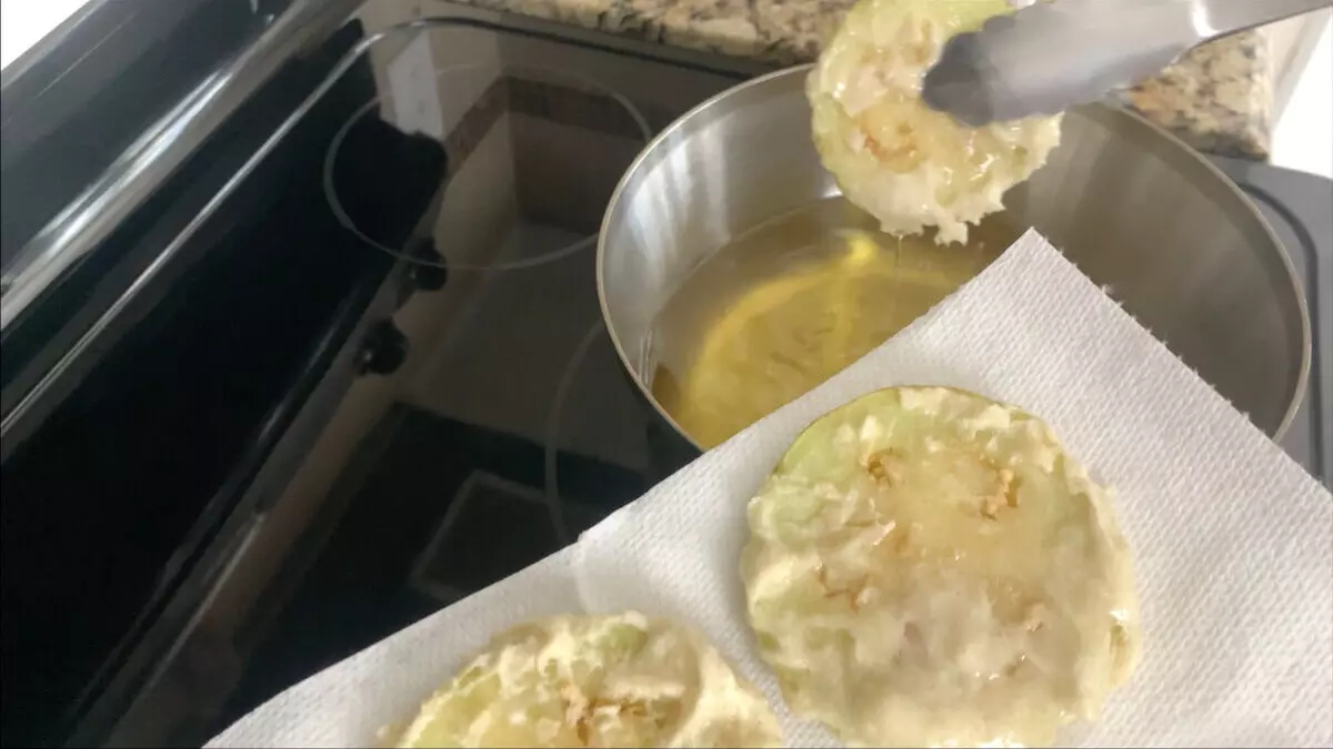 Removing eggplant tempura from oil. 