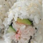 Close up of California roll sushi on a white plate.