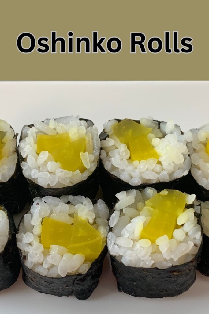 Close up of Oshinko roll sushi served maki style on a white plate.