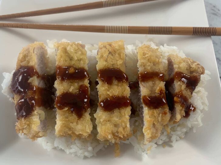 Pork tonkatsu, sliced on a bed of rice drizzled with katsu sauce.
