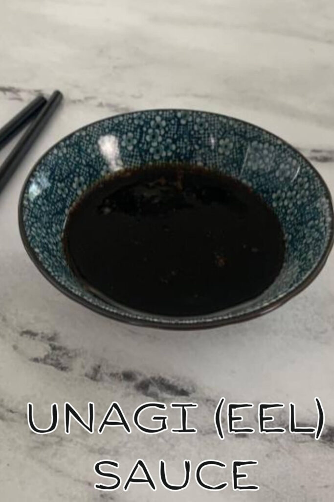 Unagi (eel) sauce closeup in a Japanese bowl with black chopsticks in the background.