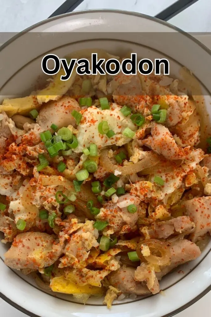 Oyakodon vertical thumbnail in a Japanese bowl with chopsticks in the background