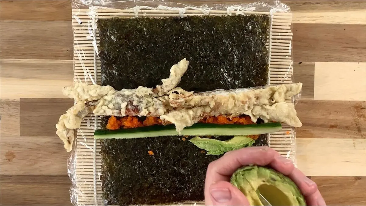 Add cucumber strip and avocado slices to your spider roll. 