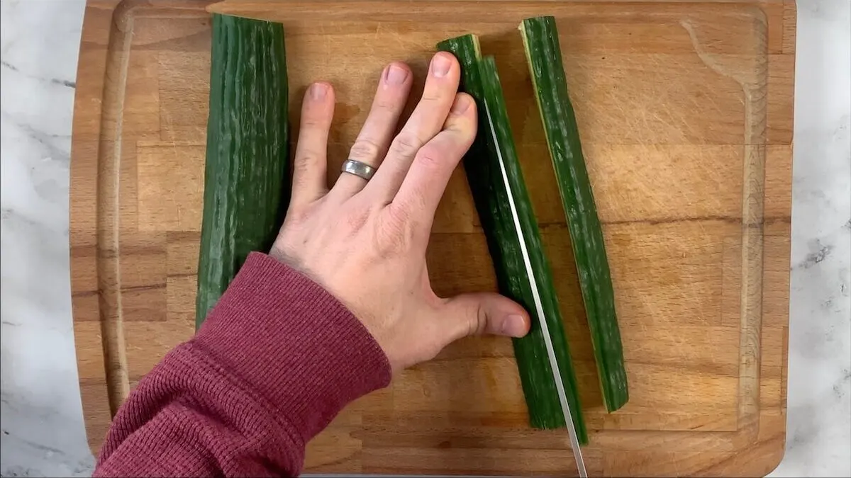 Slice cucumbers into strips for the vegetable roll. 