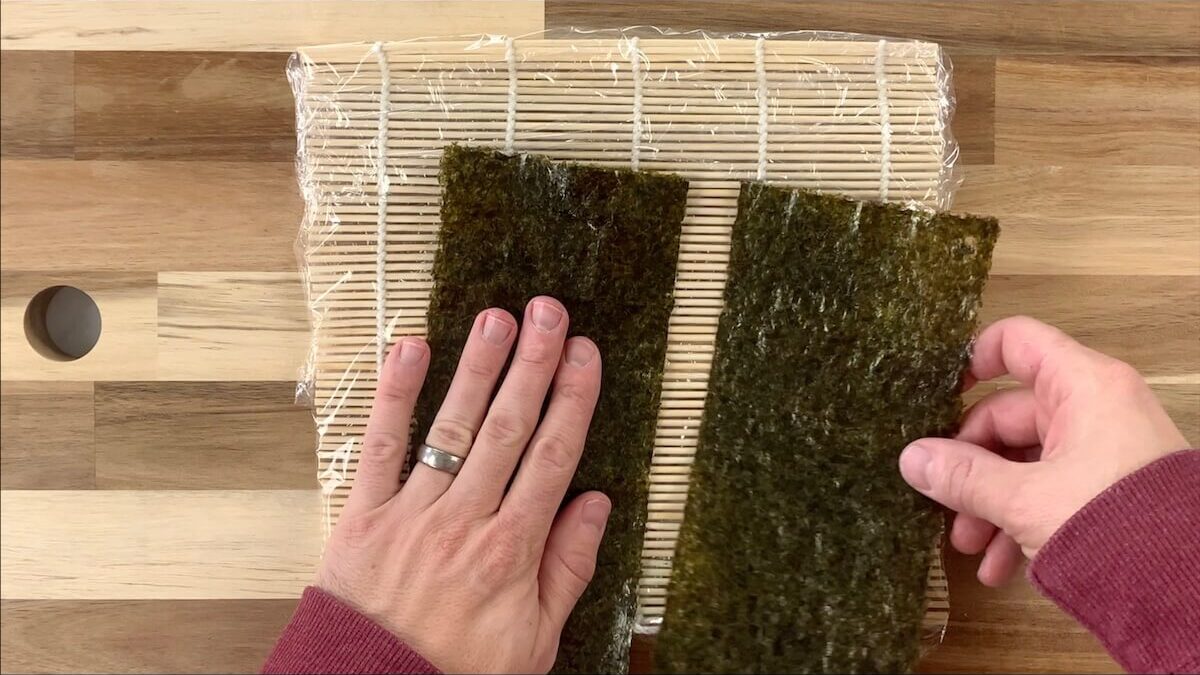 Tear the nori sheet half.  This will make the avocado roll smaller and easier to eat with chopsticks.