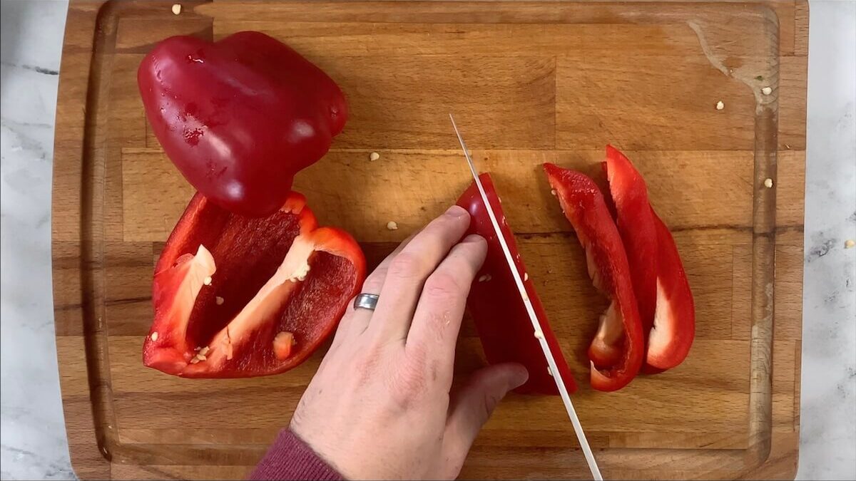 Slice red bell pepper into strips. 
