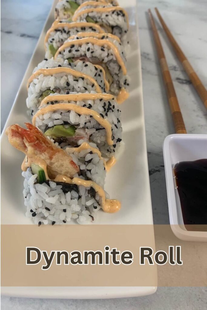 Vertical photo of dynamite rolls served on a white sushi plate with chopsticks and unagi sauce in the background.