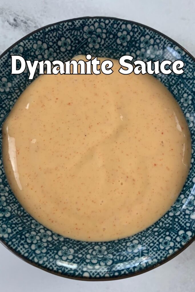 Close up of dynamite sauce (spicy mayo) in a blue Japanese ramekin.