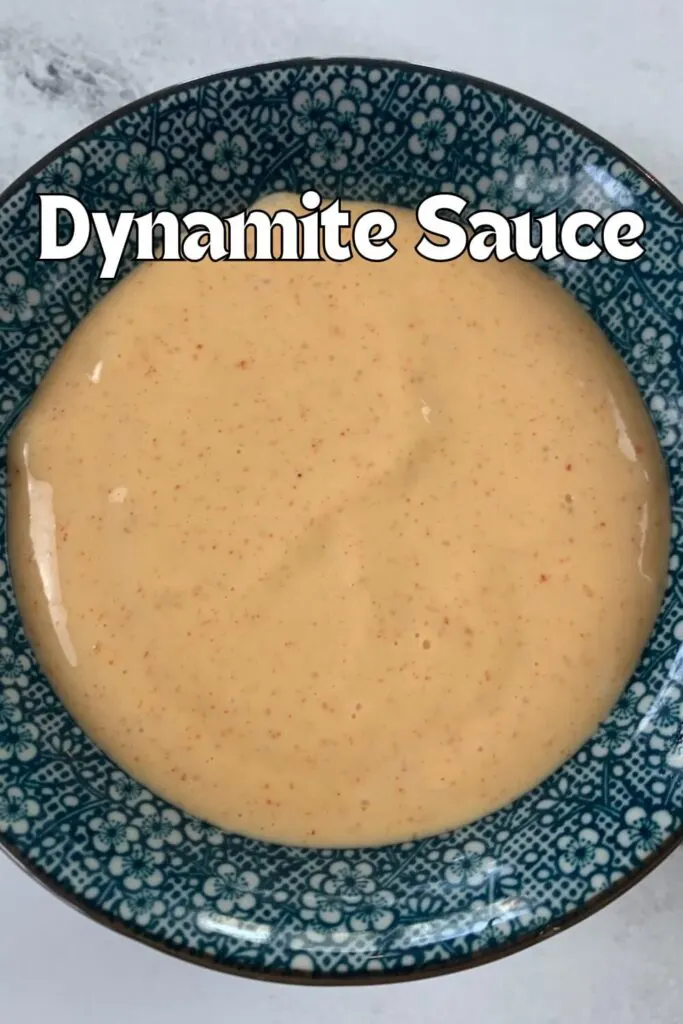 Close up of dynamite sauce (spicy mayo) in a blue Japanese ramekin.