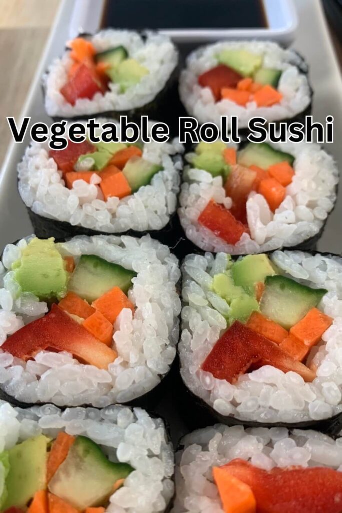Vegetable roll sushi vertical picture arranged on a white sushi plate with a ramekin of soy sauce in the background.