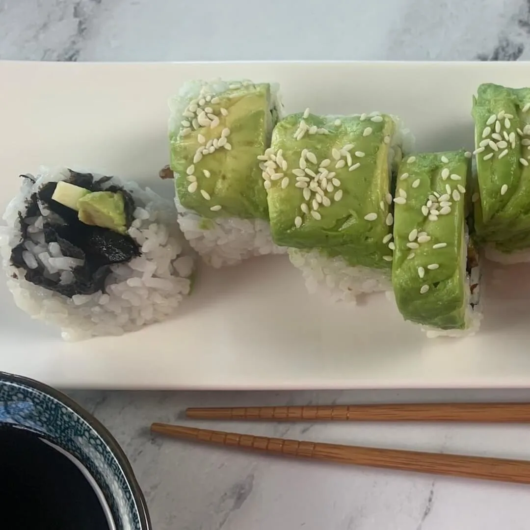 Caterpillar roll square thumbnail pic with a ramekin of soy sauce and chopsticks in the background