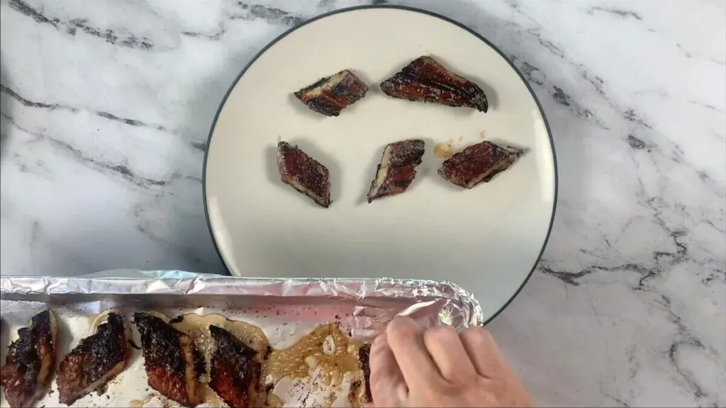 Remove broiled eel from baking sheet. 