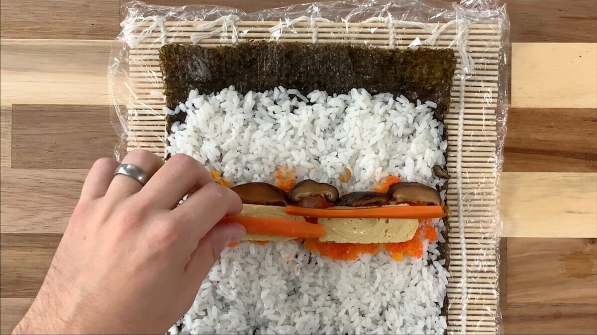 Add mushrooms and carrots to the futomaki roll