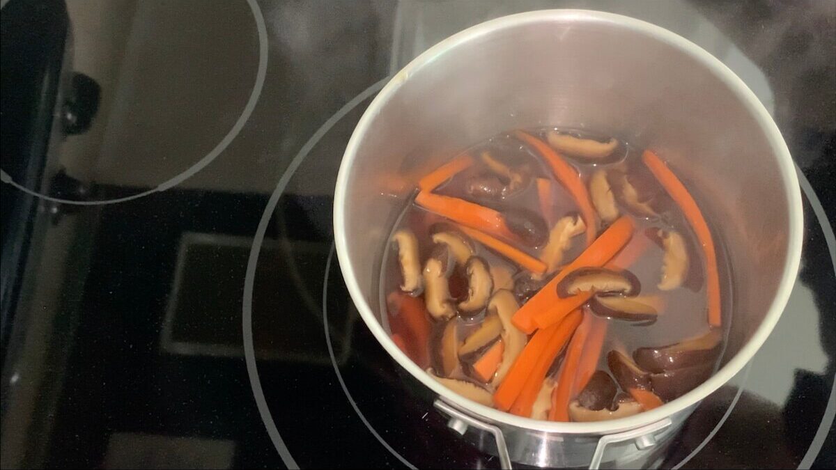 Simmer mushrooms and carrots for ten minutes.