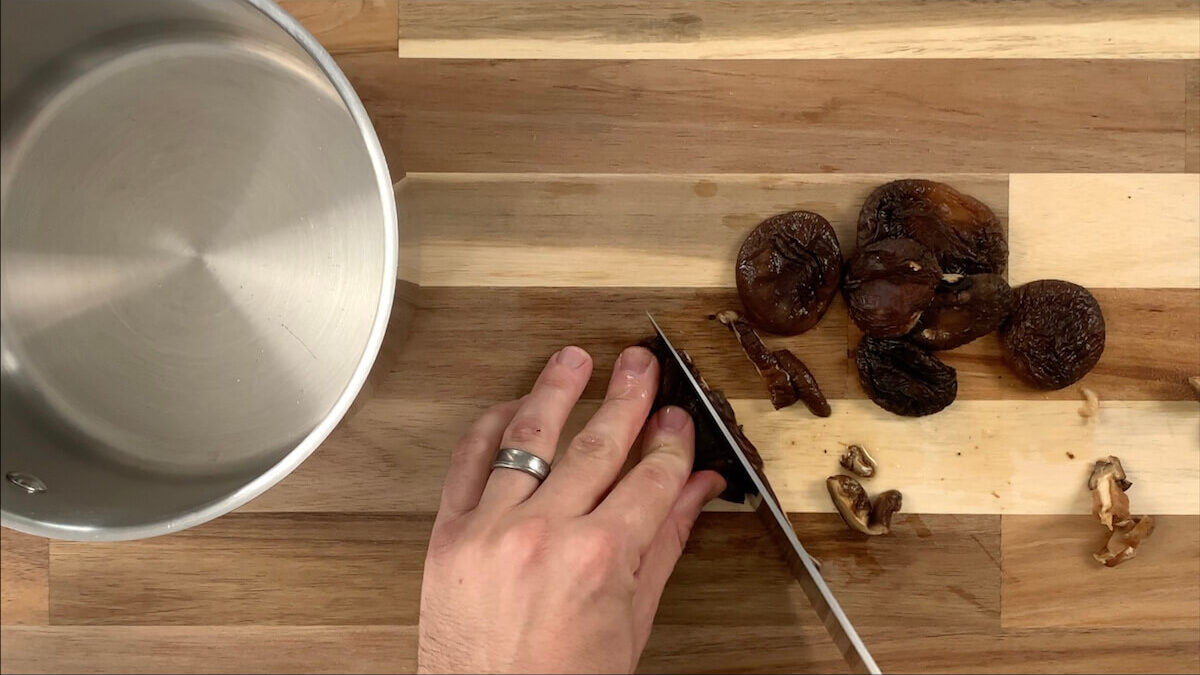 Cut stems off of shiitake mushrooms and slice into thin slices.